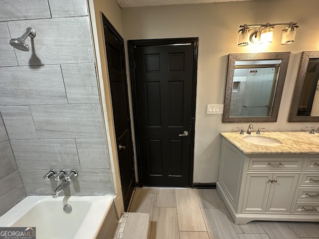 bathroom with vanity and bathtub / shower combination