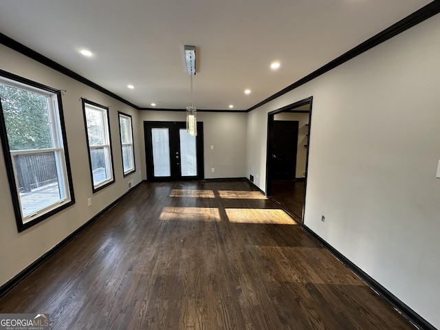 spare room with dark hardwood / wood-style flooring, french doors, and ornamental molding