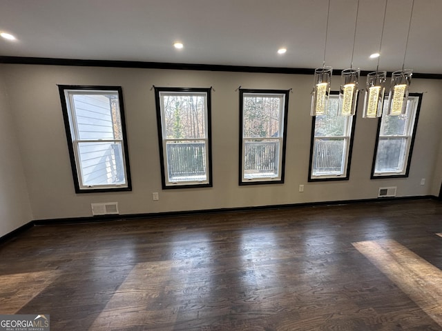 interior space featuring dark hardwood / wood-style flooring and crown molding