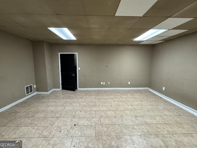 unfurnished room featuring a paneled ceiling