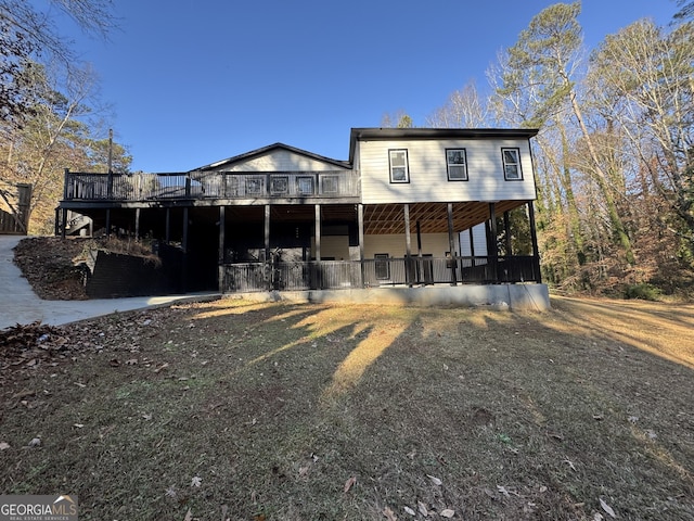 rear view of house featuring a wooden deck