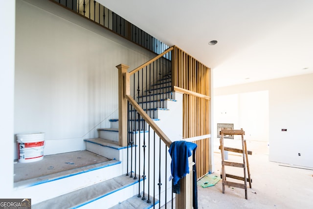 stairway featuring concrete flooring