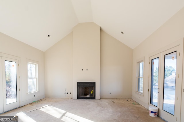 unfurnished living room with a wealth of natural light and lofted ceiling