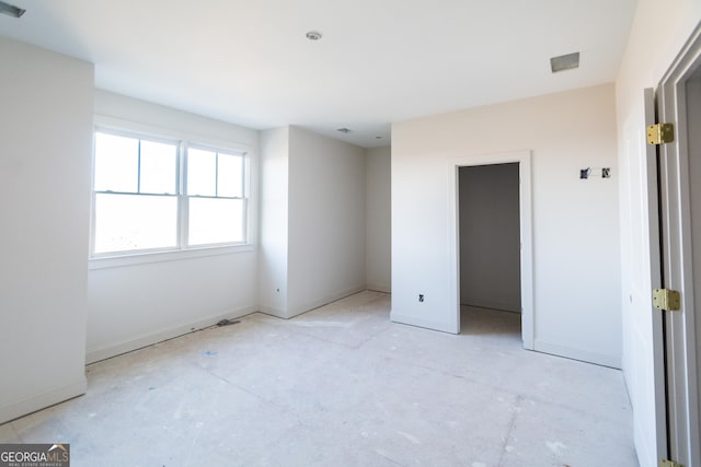 unfurnished bedroom with a spacious closet