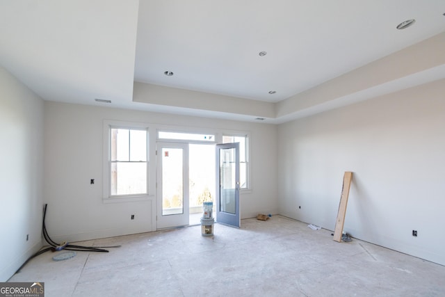 spare room featuring a raised ceiling