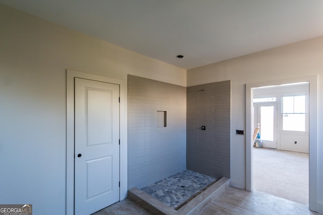 bathroom with a tile shower