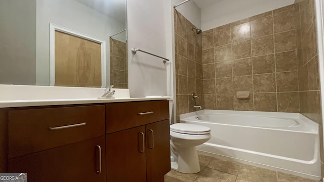 full bathroom featuring vanity, tiled shower / bath combo, and toilet