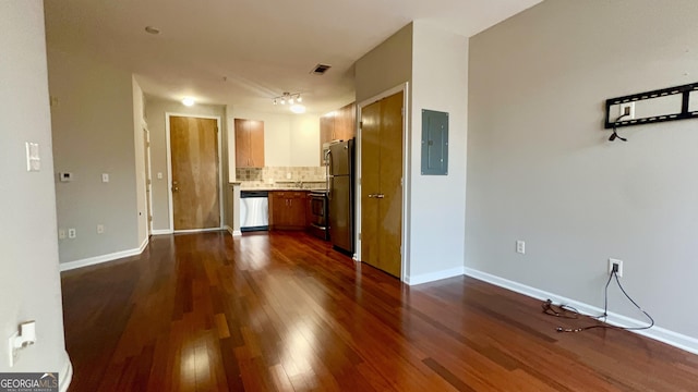 unfurnished living room featuring dark hardwood / wood-style floors and electric panel