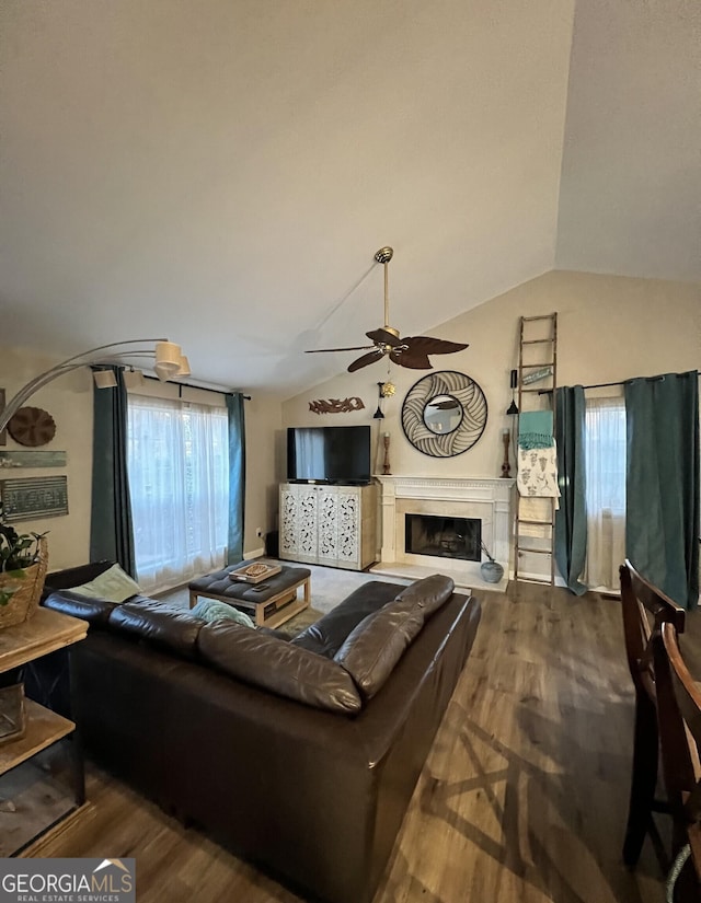 living room featuring ceiling fan, dark hardwood / wood-style flooring, and lofted ceiling