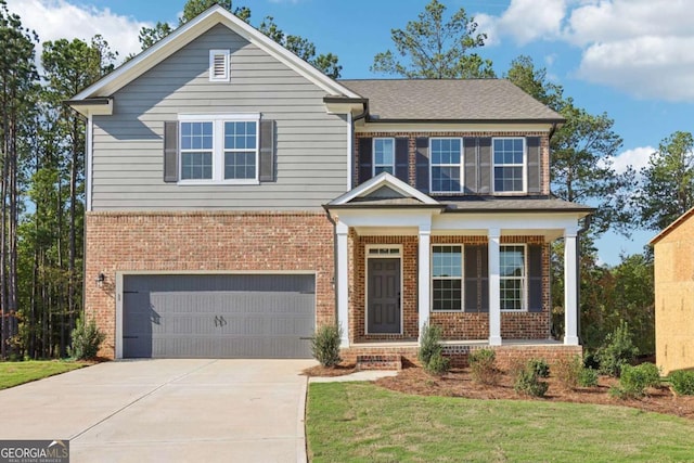 view of front of property featuring covered porch, a front yard, and a garage