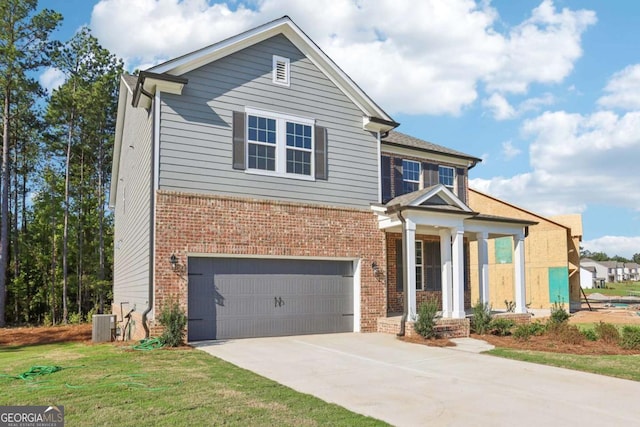 view of front of house with central AC, a front yard, and a garage