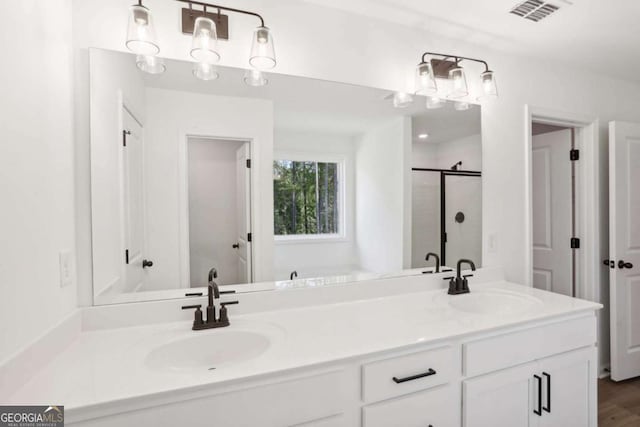 bathroom featuring vanity and a shower with door