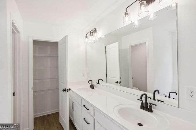 bathroom featuring hardwood / wood-style floors, vanity, and toilet