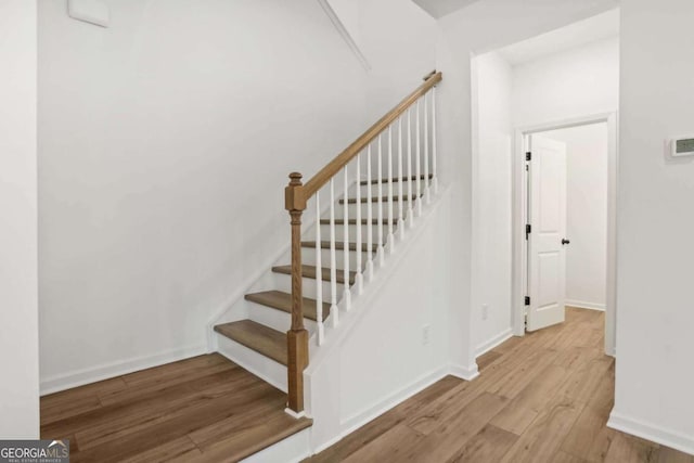 stairs featuring wood-type flooring