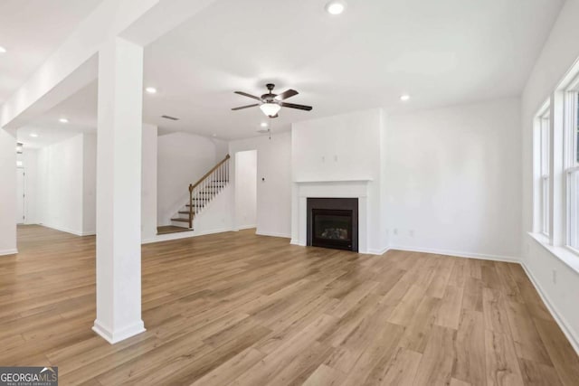 unfurnished living room with light hardwood / wood-style floors, plenty of natural light, and ceiling fan