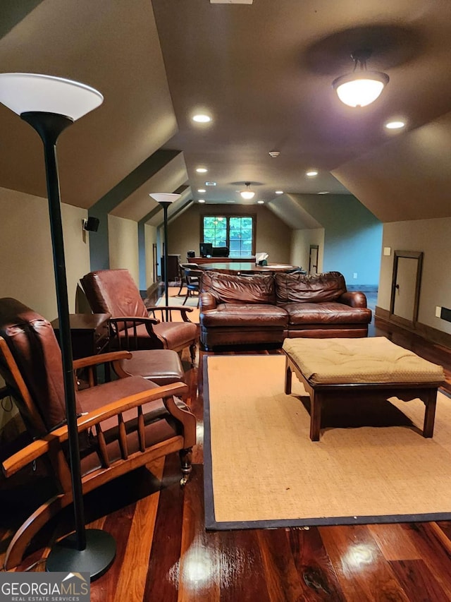 living room with dark hardwood / wood-style floors and lofted ceiling