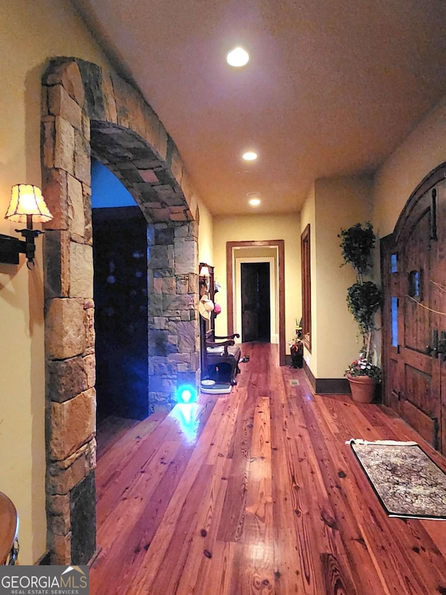 corridor with wood-type flooring