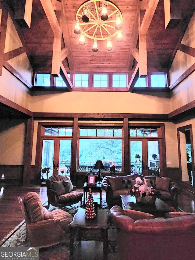 living room with french doors, high vaulted ceiling, and wooden ceiling