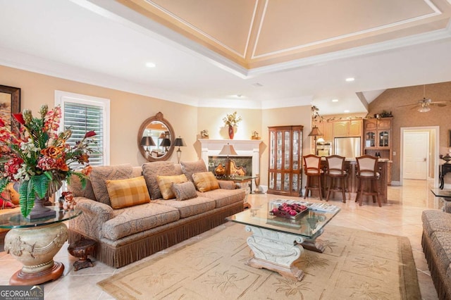 living area featuring ceiling fan and crown molding