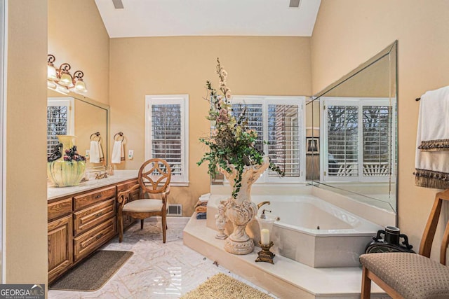 bathroom with vanity and a tub