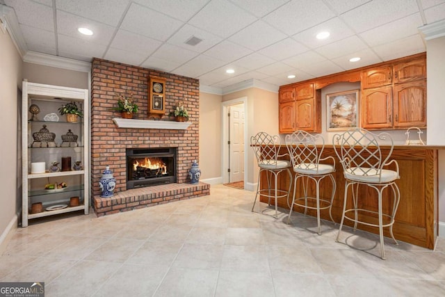 kitchen with a breakfast bar and ornamental molding