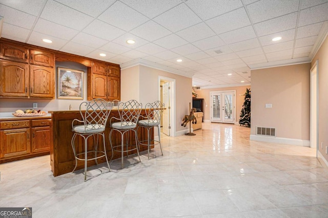 carpeted bedroom with a tray ceiling, ceiling fan, and ornamental molding