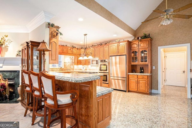 kitchen with decorative backsplash, decorative light fixtures, a center island, and stainless steel appliances