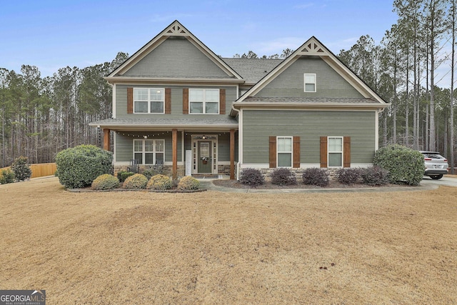 craftsman-style home with a front yard