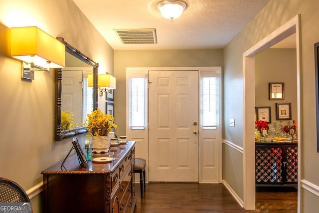 carpeted bedroom featuring ceiling fan, ensuite bathroom, and a textured ceiling