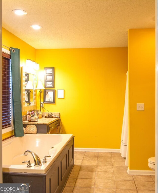 bedroom featuring ceiling fan, light colored carpet, sink, and ensuite bath