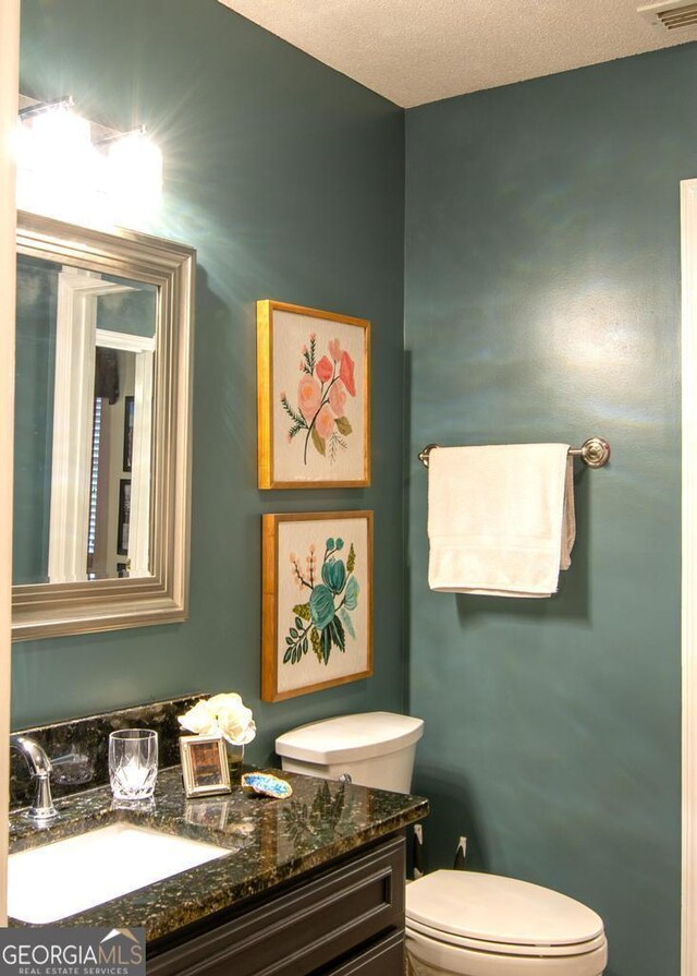 bathroom with vanity and a textured ceiling