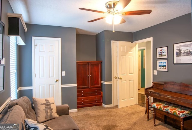 carpeted bedroom featuring a textured ceiling and ceiling fan