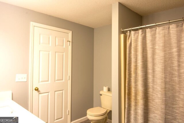 bathroom with a textured ceiling, vanity, and hardwood / wood-style flooring