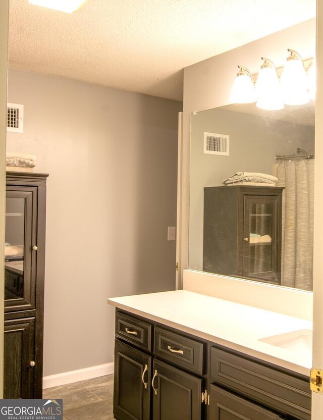 home office with light carpet, a textured ceiling, and ceiling fan