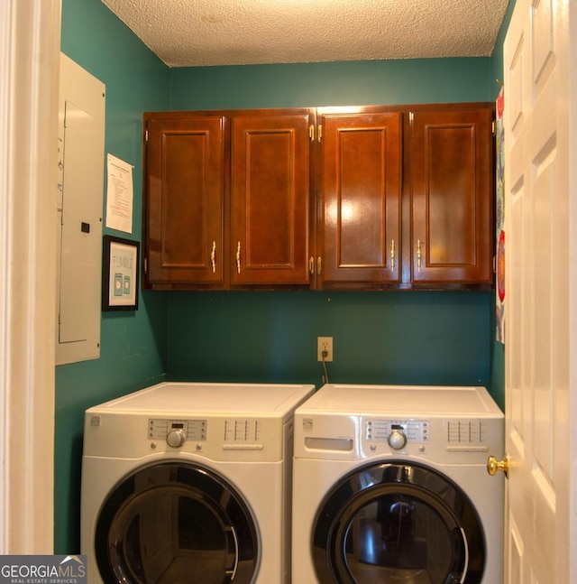 clothes washing area featuring cabinets, independent washer and dryer, a textured ceiling, and electric panel