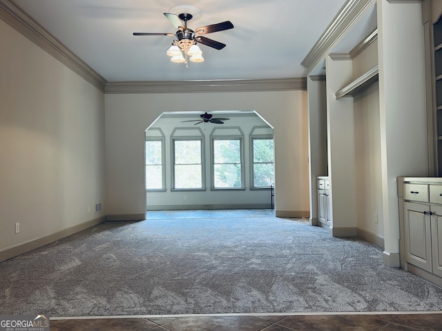 unfurnished living room with ceiling fan, carpet, and ornamental molding