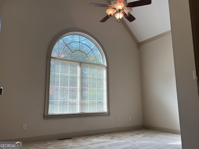 carpeted empty room featuring ceiling fan and lofted ceiling