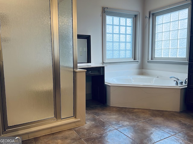 bathroom with vanity and independent shower and bath