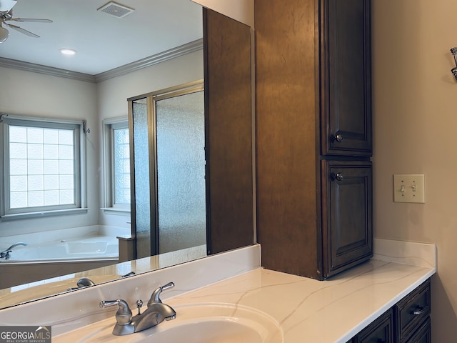 bathroom with crown molding, vanity, and independent shower and bath