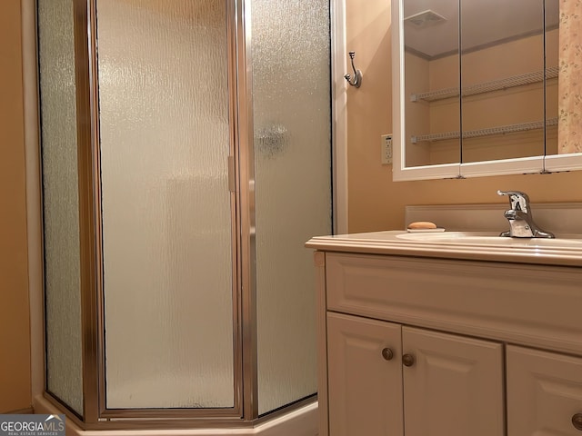 bathroom featuring vanity and a shower with shower door