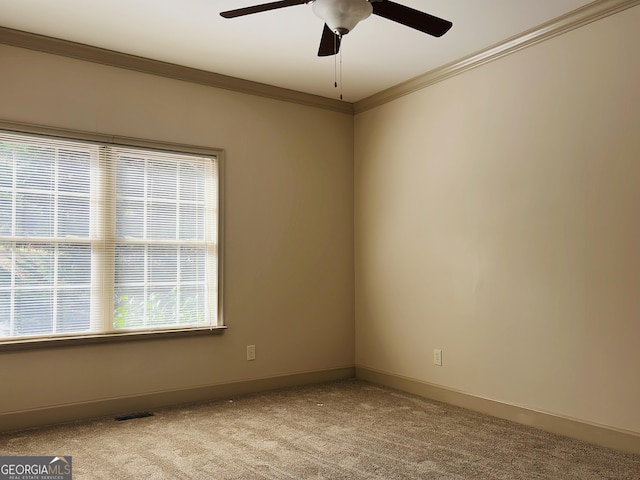 spare room with crown molding, ceiling fan, and light carpet