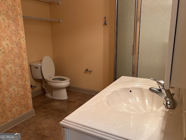 bathroom featuring tile patterned flooring, vanity, toilet, and curtained shower