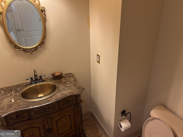 bathroom with tile patterned floors, vanity, and toilet