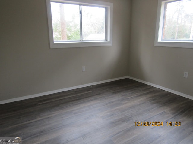 unfurnished room with dark hardwood / wood-style floors