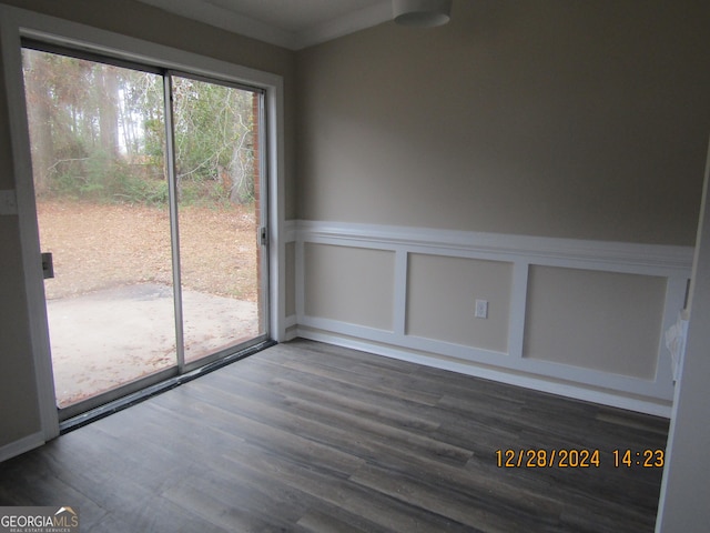 empty room with hardwood / wood-style floors and ornamental molding