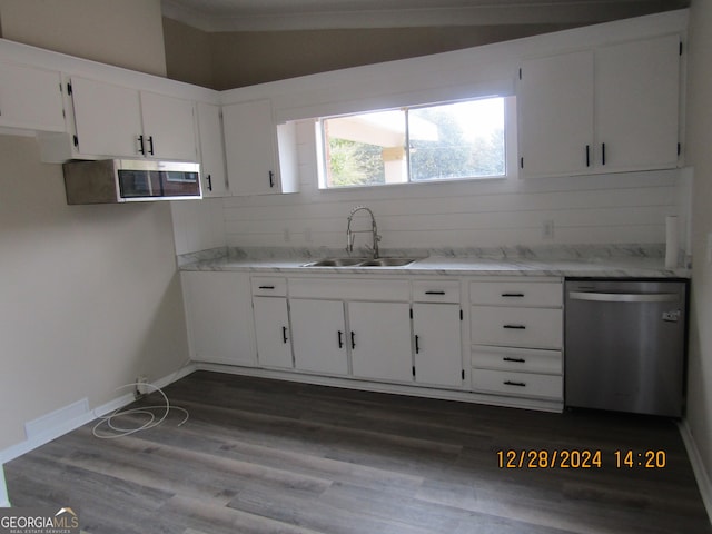 kitchen with light stone countertops, white cabinetry, sink, stainless steel appliances, and dark hardwood / wood-style flooring