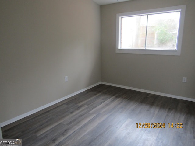 unfurnished room with dark hardwood / wood-style flooring