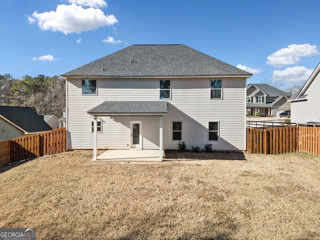 rear view of property featuring a patio area and a lawn