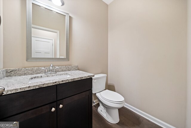 bathroom featuring vanity, toilet, and wood-type flooring