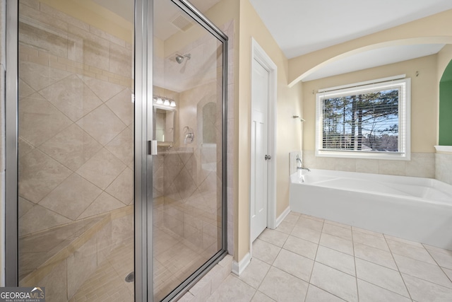 bathroom with separate shower and tub and tile patterned floors